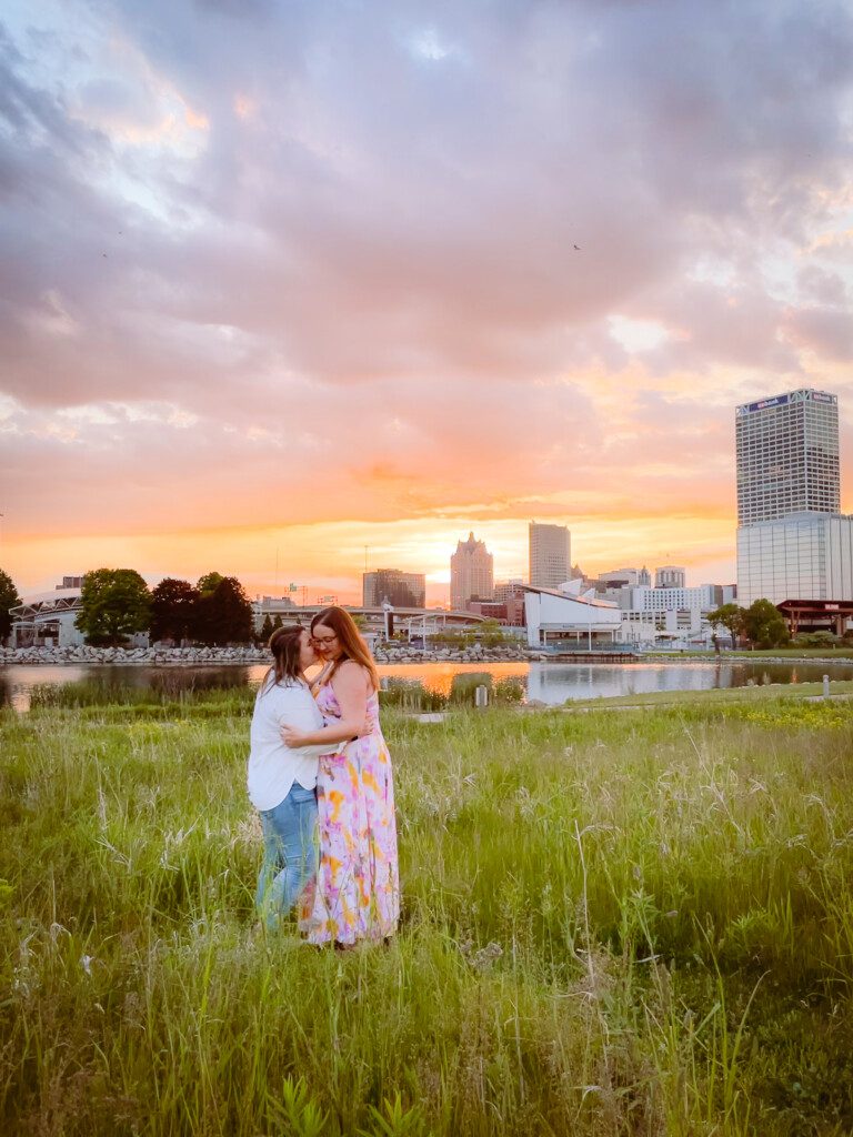 two women in front of city sunset
