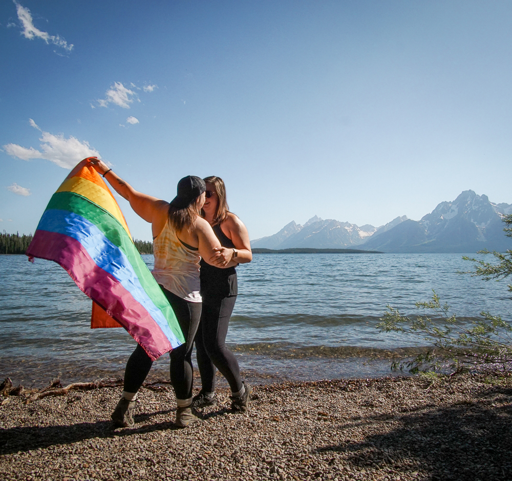LGBTQ women with rainbow flag at Grand Teton National Park