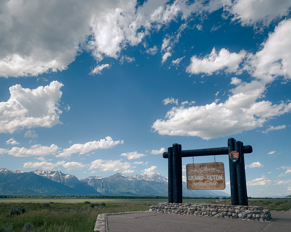 Grand Teton National Park Welcome Sign with Mountains in Background