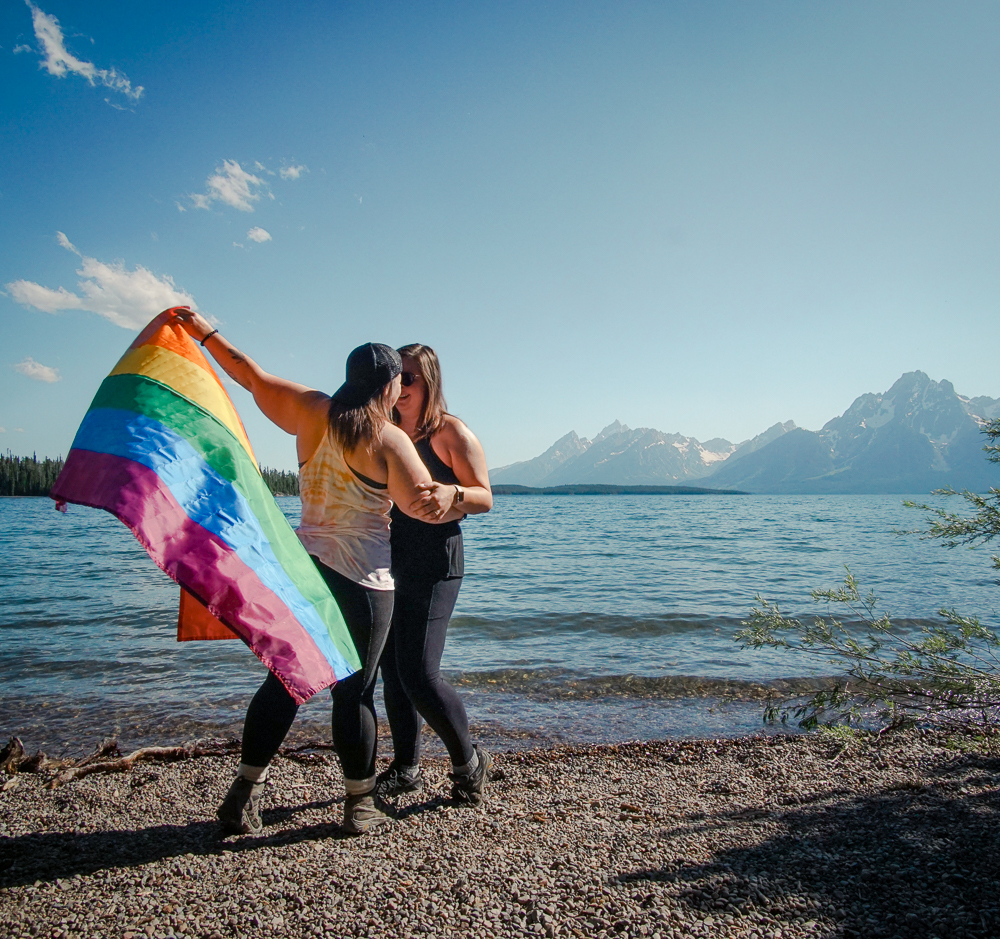 Lesbian couple with pride flag at Grand Teton