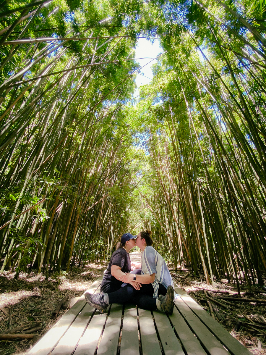Lesbian couple kissing in bamboo forest