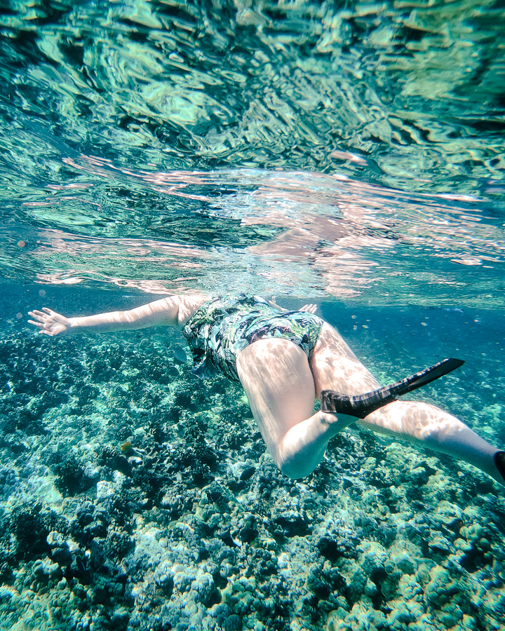 Woman snorkeling under water at Molokini crater