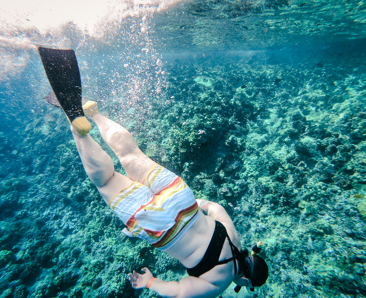 Woman snorkeling underwater at Molokini crater