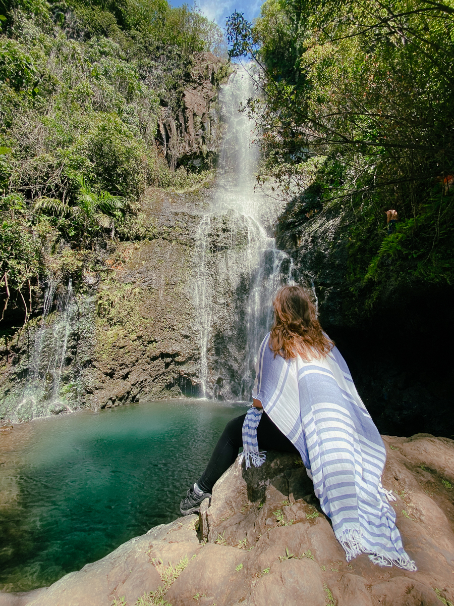 Woman sitting in front of Wailua Falls