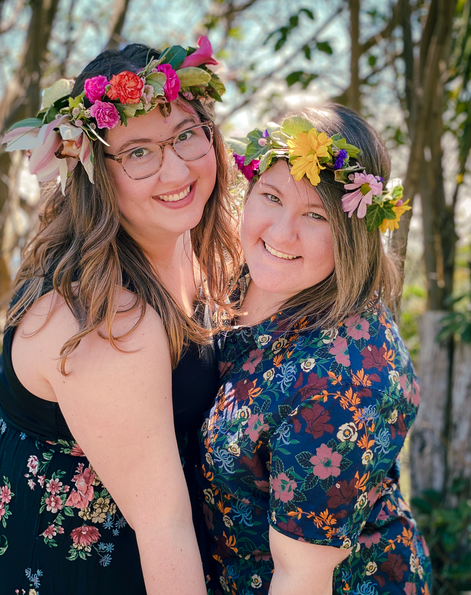 Two smiling women with Haku Maui flower crowns