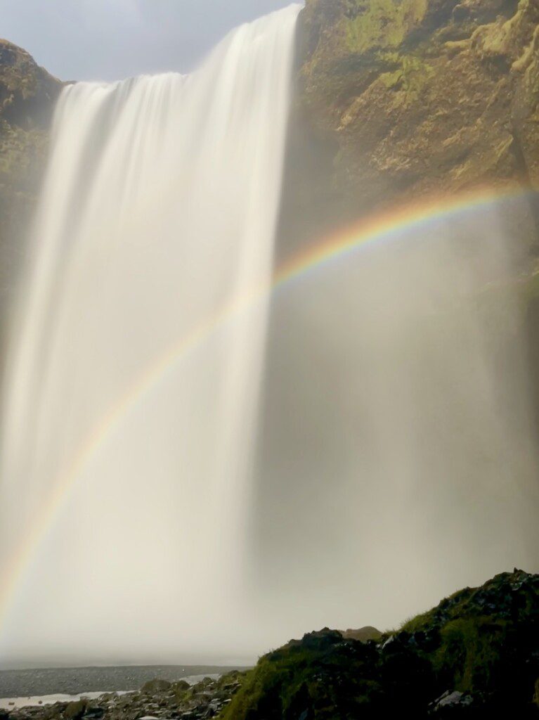 Rainbow in front of large Skogafoss Waterfall