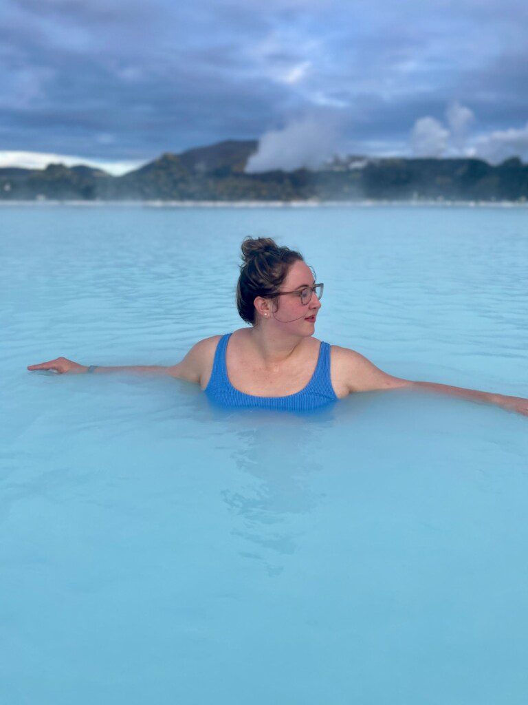 Woman swimming in milky blue waters of Blue Lagoon Iceland on Iceland five day ring road itinerary