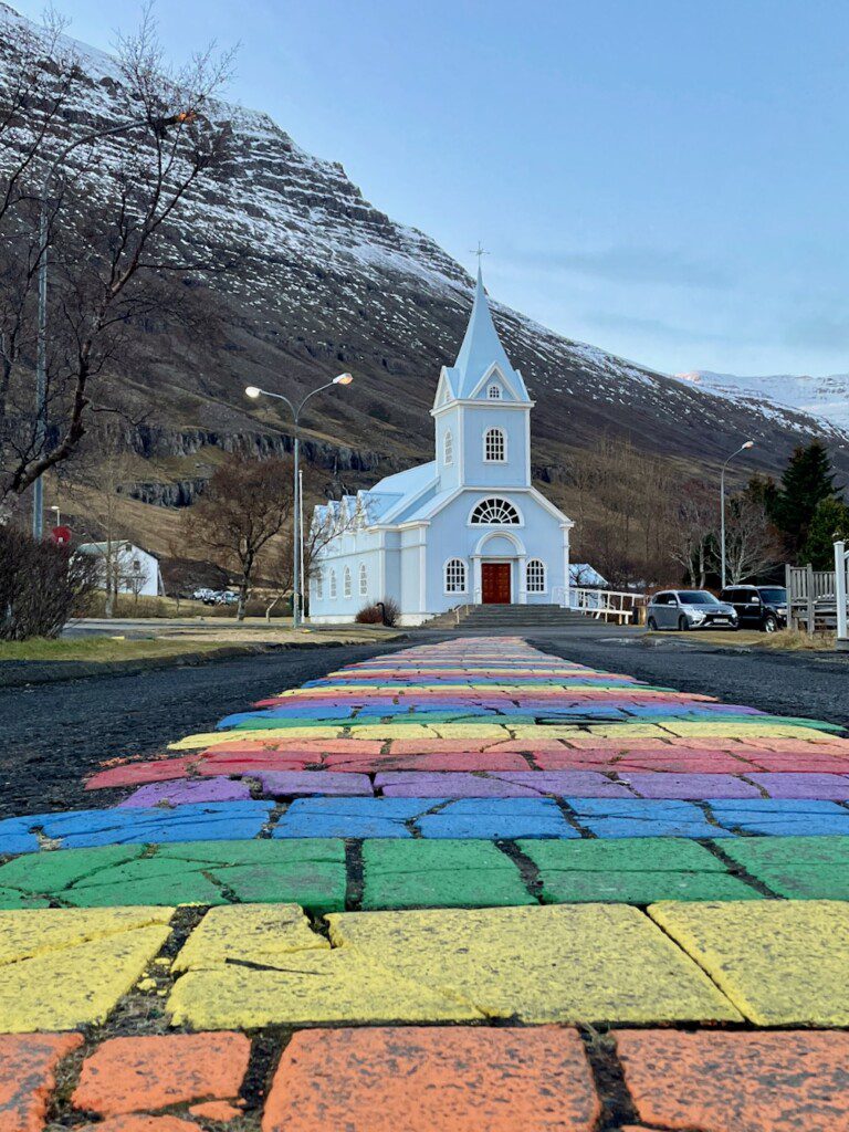 Rainbow sidewalk leading up to church in Seydisfjordur on Iceland five day ring road itinerary